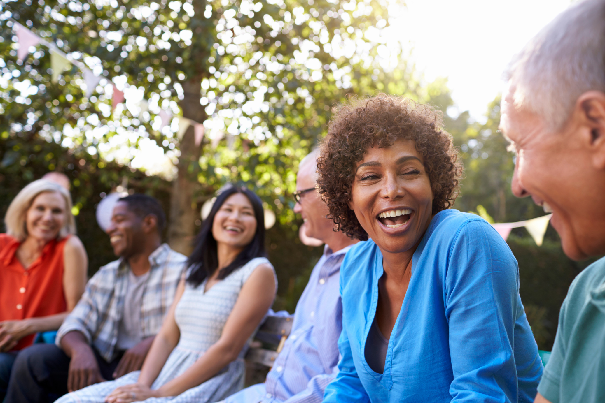 Group of Mature Friends Socializing in Backyard Together